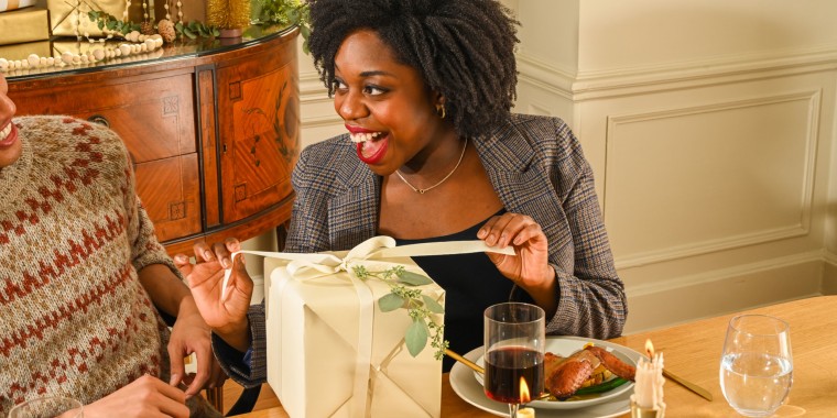 Woman opening a gift at the table