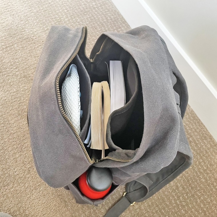 Terra Thread's canvas backpack holds a lot: For one trip, I packed it with two books, a crossword puzzle book, two masks, my over-ear headphones, my work laptop and a water bottle (it easily fits two).