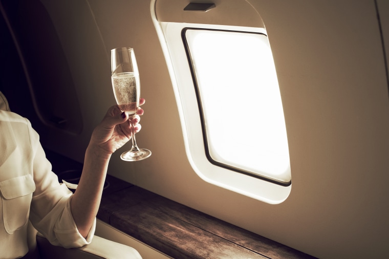 Businesswoman relaxing aboard private jet.