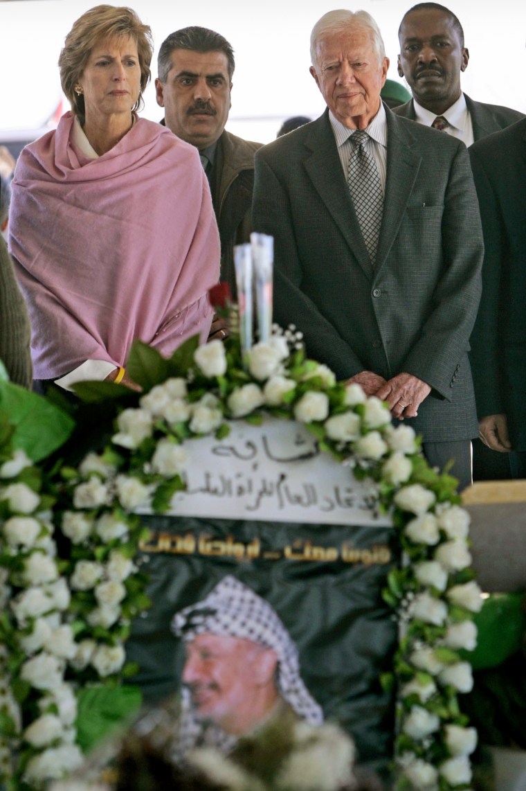 Former President Jimmy Carter and former New Jersey Gov Christine Todd Whitman pay their respect at the grave of late Palestinian leader Yasser Arafat