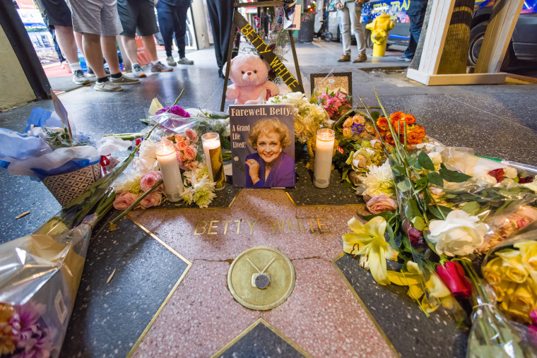 Flowers and mementos in honor of Betty White are seen at her star on the Hollywood Walk of Fame on on December 31, 2021 in Los Angeles, California.