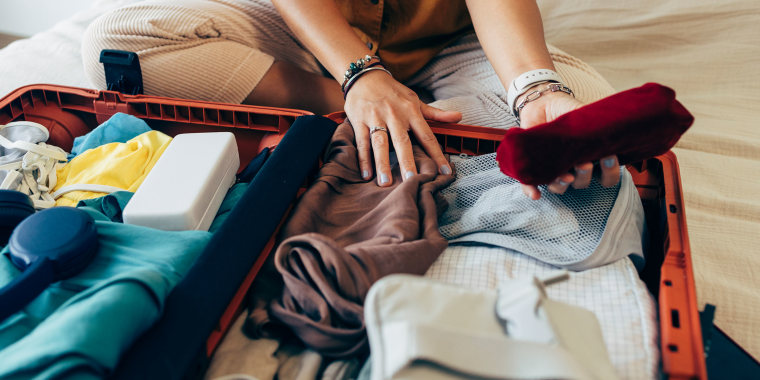 An unrecognizable female tourist packing her suitcase in a hotel room after a much needed vacation.