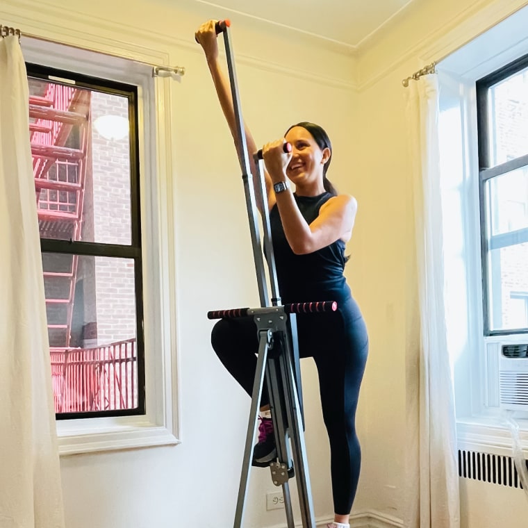 Woman using the MaxiClimber vertical climber in her home