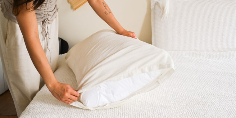 Woman putting on a pillow case