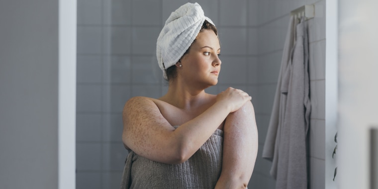 Beautiful Plus Size Woman Applying Body Lotion after Taking a Shower