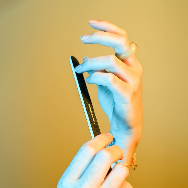 Woman filing her nails