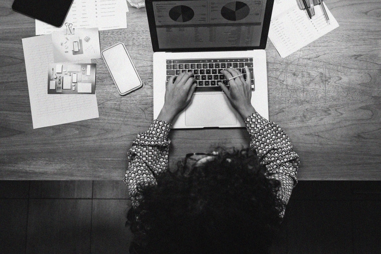 Overhead view of a Black woman working on a laptop