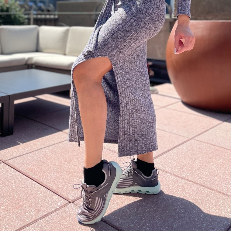 Woman posing in sneakers outside