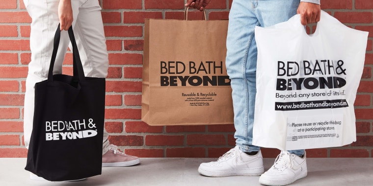 Hand holding some Bed Bath and Beyond bags