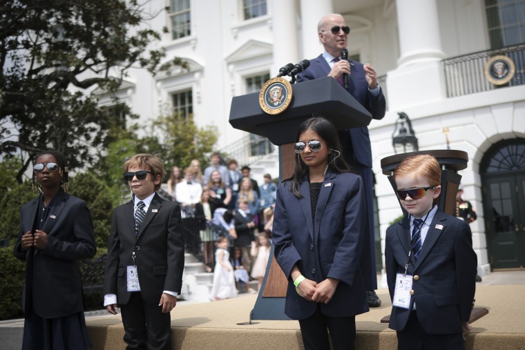 U.S. President Joe Biden speaks while children dressed as Secret Service agents \"guard\" the stage on Take Your Child To Work Day April 27, 2023 in Washington, DC. The National Take Your Child To Work Day reached its 30th anniversary this year.