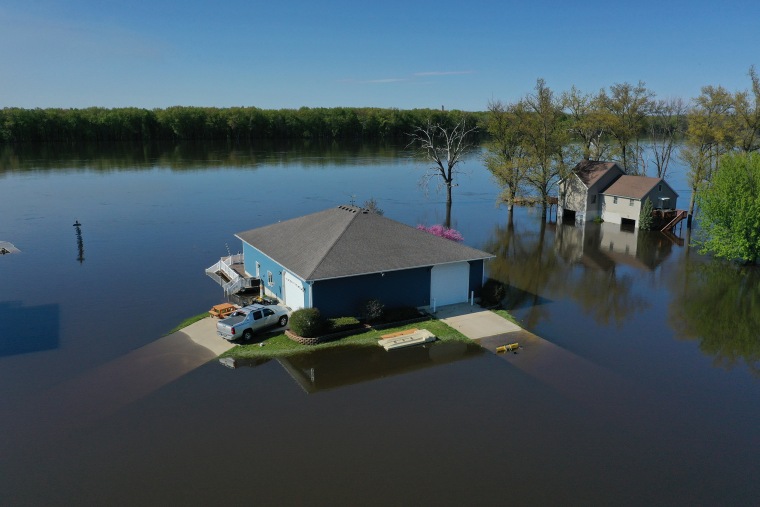 An aerial scene of the rising floodwaters of the Mississippi River surrounding homes of Albany, Illinois. The river began to crest in April, 2023 because of a rapid snowmelt, flooding homes, streets and businesess.