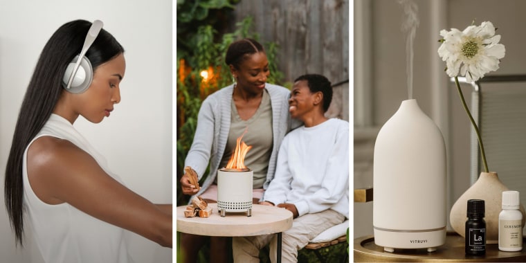 Woman wearing Bose headphones a Mom and son by a mini firepit and a Vitruvi diffuser