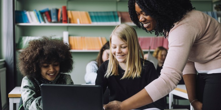 Teacher interacting with her students in the classroom
