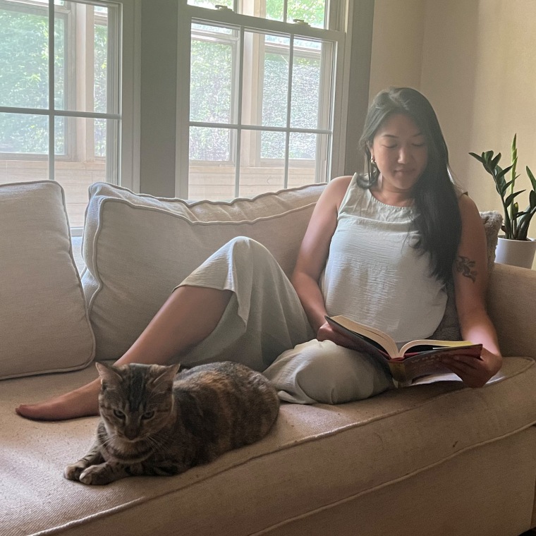 Woman wearing a black beige two-piece set lounging on the couch