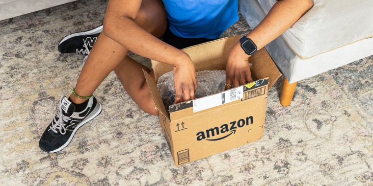 Close up of a Woman on the floor opening up an Amazon box