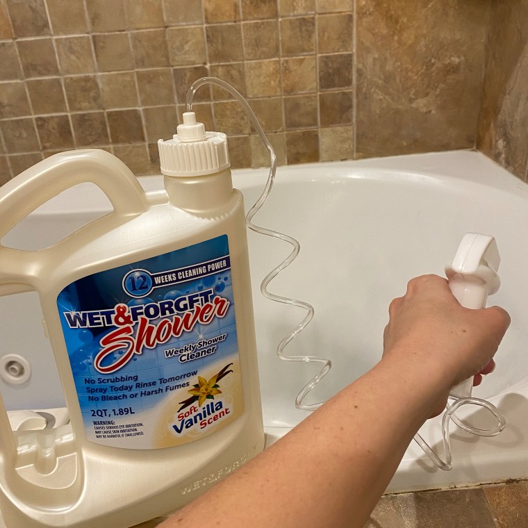 Woman spraying shower cleaner