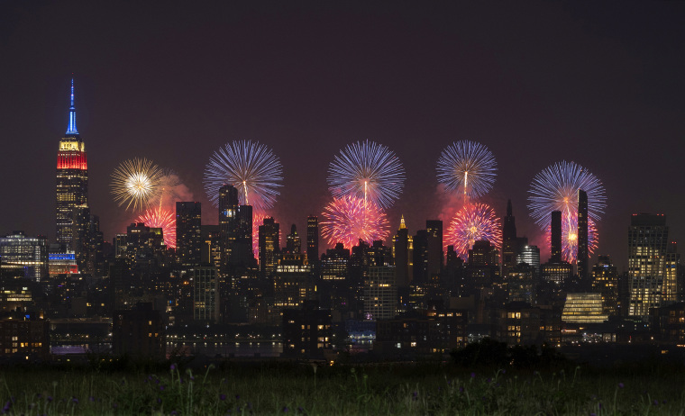 Macy's 4th of July fireworks light up the sky next to the Empire State Building in New York City on July 4, 2023, as seen from Union City, New Jersey.