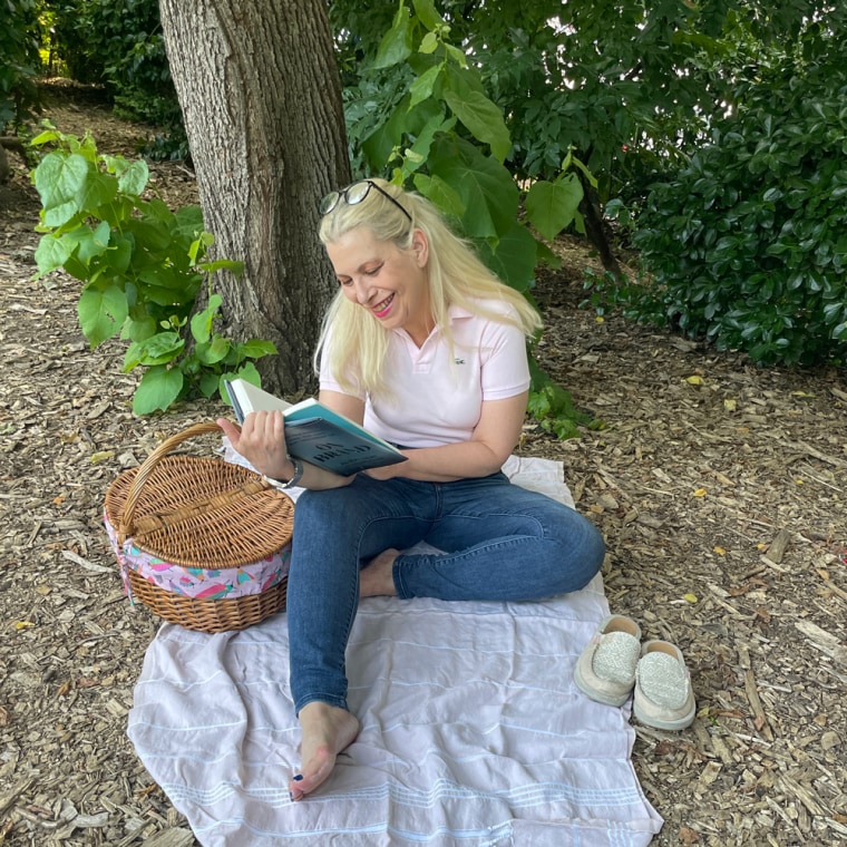 Woman sitting outside reading