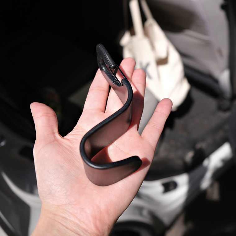 Hand holding a black car hook