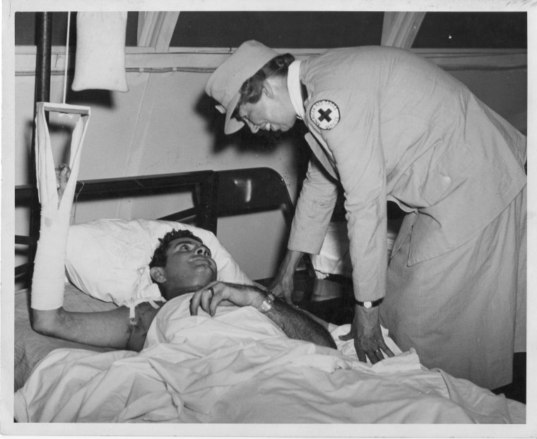 Eleanor Roosevelt speaks with an injured sailor at a South Pacific hospital.