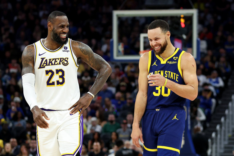 LeBron James #23 of the Los Angeles Lakers and Stephen Curry #30 of the Golden State Warriors make each other laugh during a stop in play in the first half at Chase Center on January 27, 2024 in San Francisco, California.