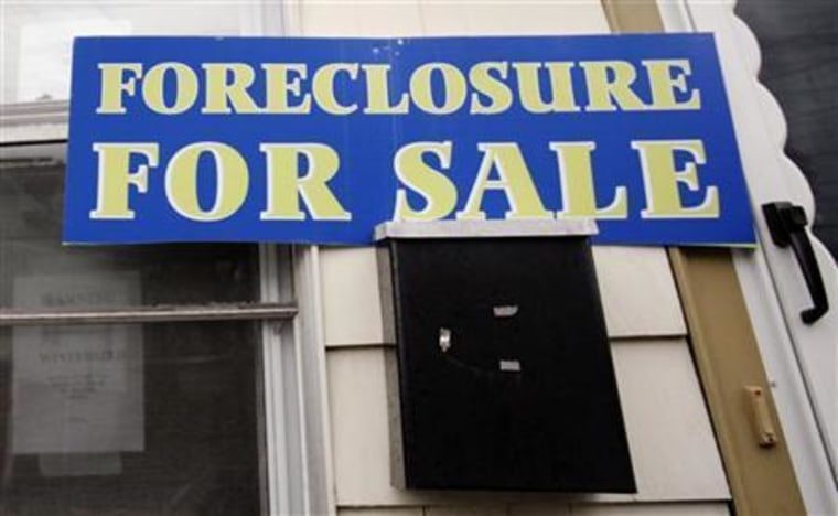 A sign reading 'Foreclosure For Sale' is posted on a house in the Boston suburb of Dedham, Mass. About 1.1 million additional home foreclosures are expected over the next six years as adjustable-rate mortgages are reset to higher payments.