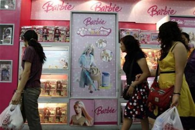 Shoppers look at Barbie & Tanner toys at a store in Beijing last month. Congress is looking into Mattel Inc's procedures for alerting federal regulators about hazardous toys. 