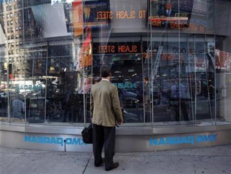 A man stands outside the NASDAQ Market Site as the televised speech by US President Bush is broadcasted in New York