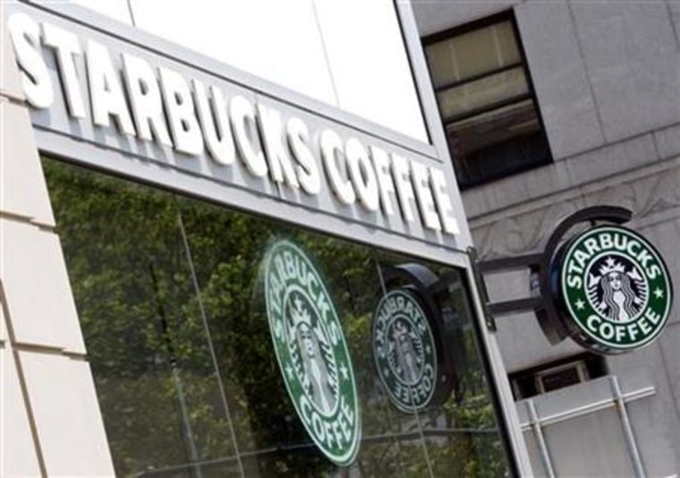Starbucks signs are seen outside one of its stores in New York