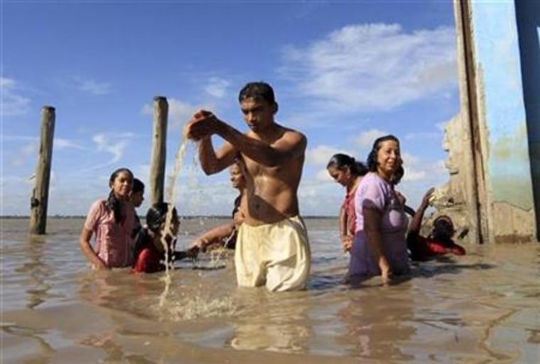 Surinamese Hindus take a ritual bath in the Suriname river on the first day of the Navratri in Paramaribo