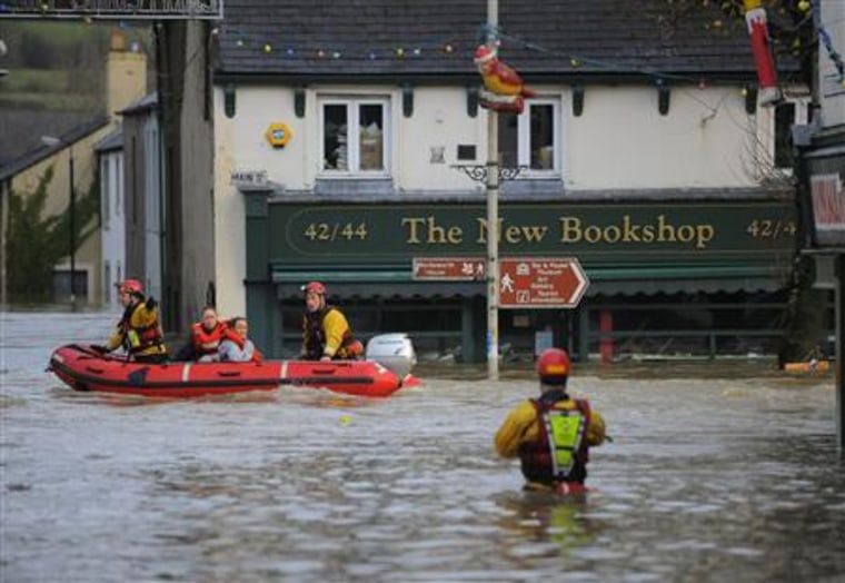 Residents are transported in a lifeboat to avoid floodwater in Cockermouth