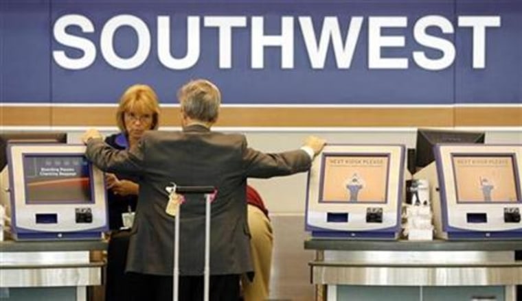 A passenger waits at the Southwest Airlines ticket counter at Midway Airport in Chicago