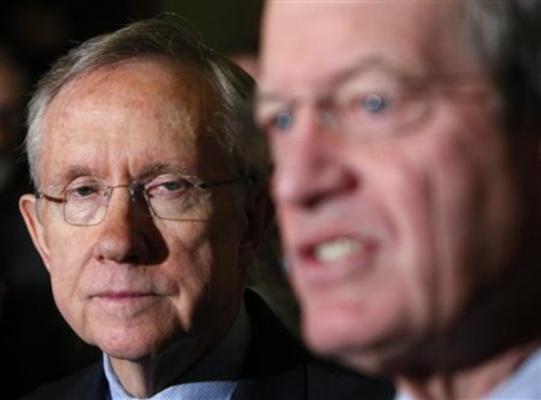 U.S. Senate Majority Leader Harry Reid (D-NV) listens to Senator Max Baucus (D-MT) in Washington