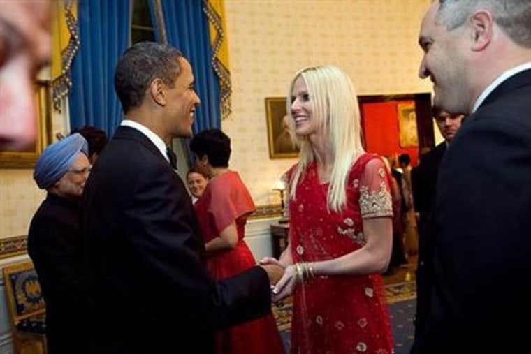 President Barack Obama greets Michaele Salahi and her husband Tareq during a state dinner for Indian Prime Minister Singh at the White House