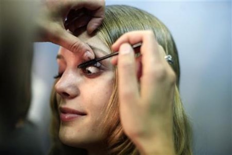 A model gets ready before presenting a creation at the Acra Spring 2010 collection during New York Fashion Week