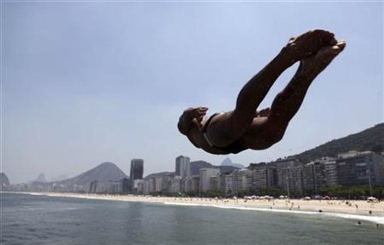 A man jumps into the waters of Leme beach in Rio de Janeiro