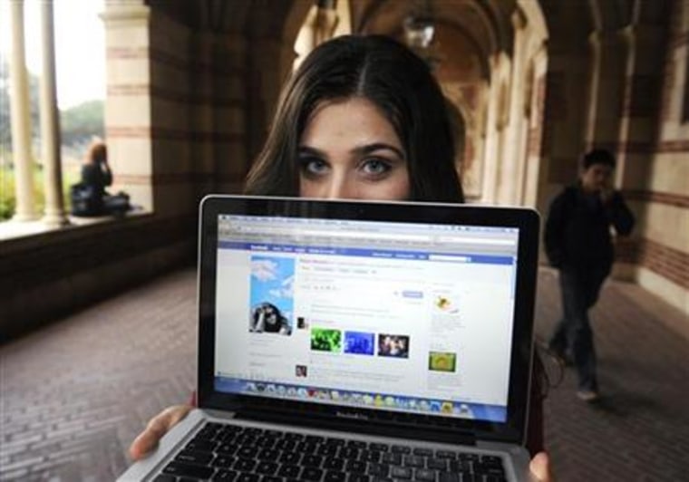 A woman displays her page on the social networking site Facebook, while attending school in Los Angeles