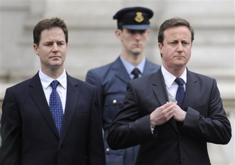 Britain's opposition Conservative Party leader Cameron stands with Liberal Democrat leader Clegg during a Victory in Europe (VE) day ceremony