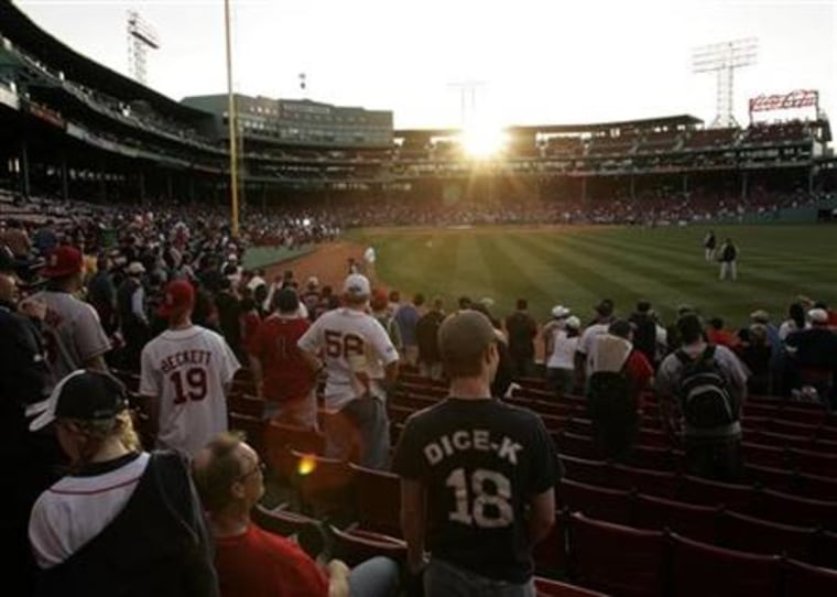 Fans arrive for MLB's 2010 season opener to watch the Yankees take on the Red Sox in Boston