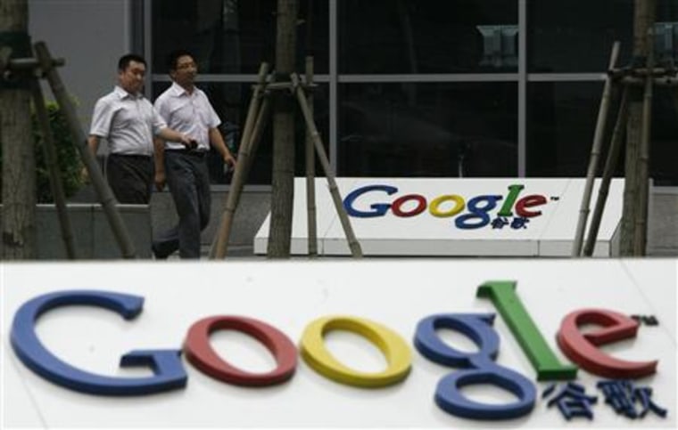 Two office workers walk out of Google's head office in Beijing