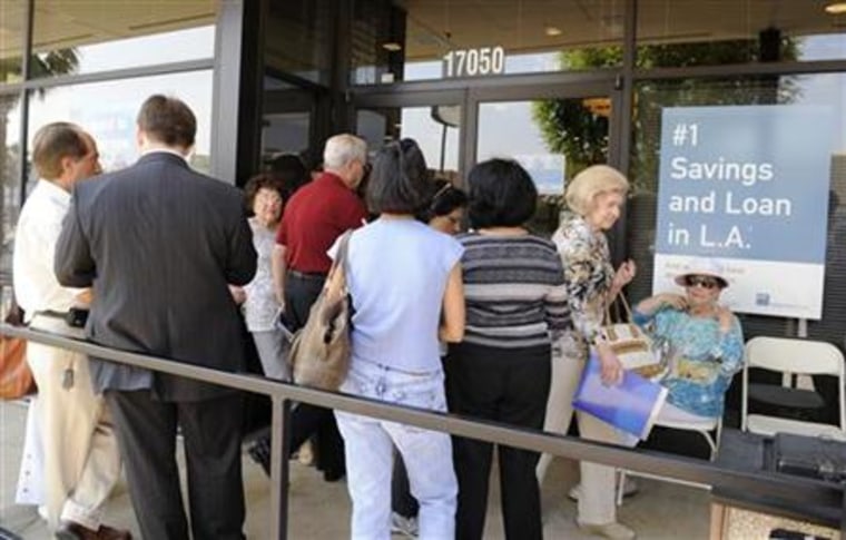 Customers wait outside the Encino branch of IndyMac Bank in Los Angeles