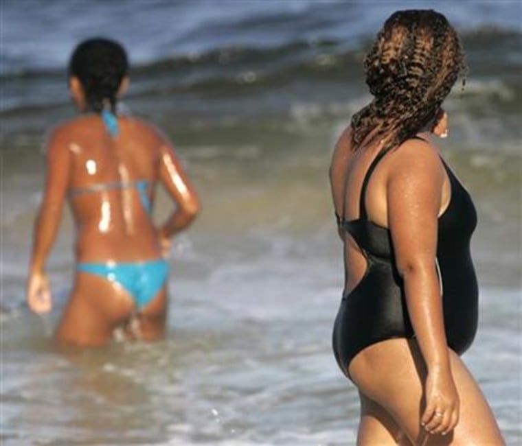 An obese Brazilian woman walks on Copacabana beach in Rio de Janeiro.
