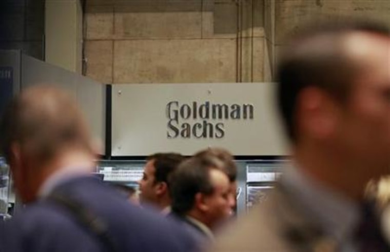 Traders work on the floor of the New York Stock Exchange near the Goldman Sachs stall