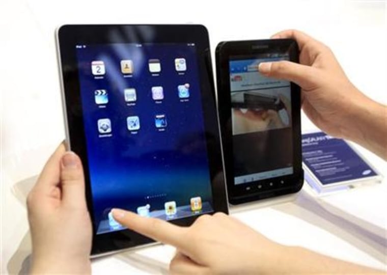 People compare the performance of Apple's iPad and Samsung's Galaxy Tab tablet devices at IFA consumer electronics fair in Berlin