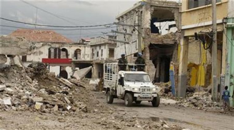 U.N. soldiers from Brazil patrol a street as they past buildings destroyed during an earthquake in downtown Port-au-Prince