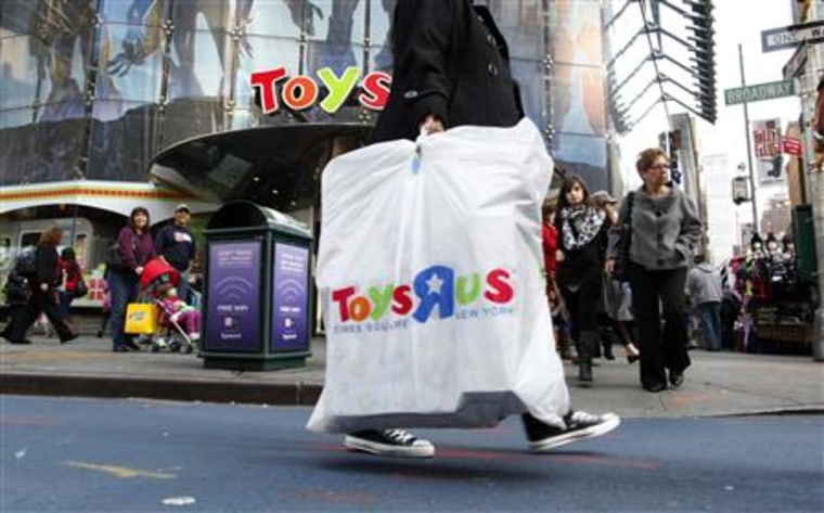 Shoppers pass by the Toys R Us store at Times Square in New York