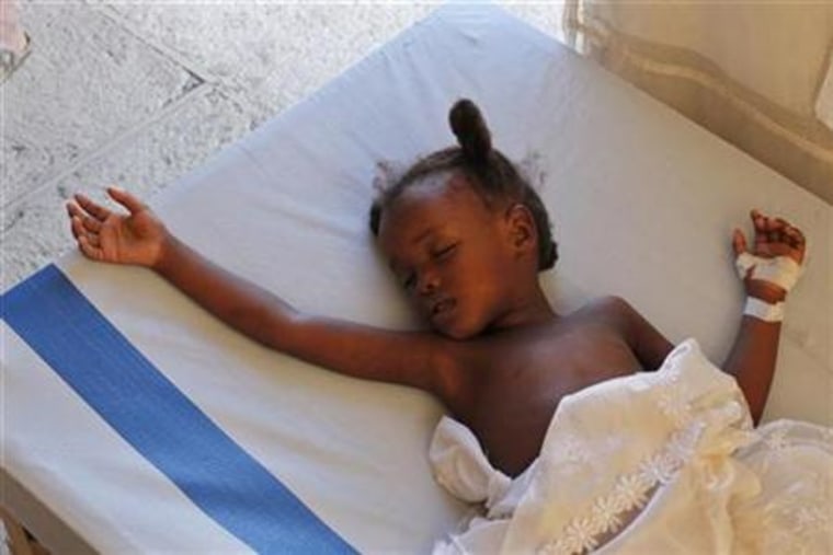 A Haitian child with cholera rests while receiving treatment in provisional clinic in Port-au-Prince