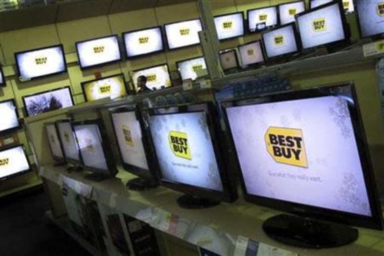 A man walks past televisions for sale at a Best Buy store in New York