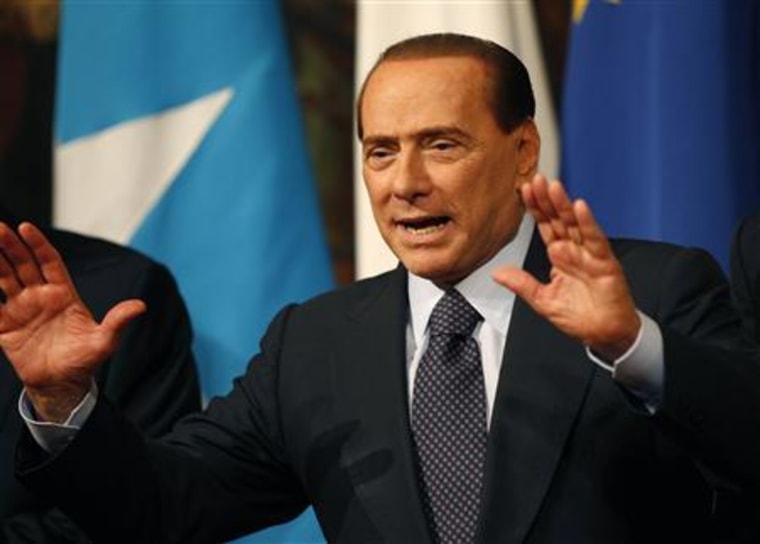 Italian Prime Minister Berlusconi reacts during a meeting with Somalia's Prime Minister Mohamed Abdullahi Mohamed at Chigi palace in Rome