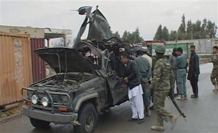 A video grab shows security personnel examining the damaged vehicle belonging to the deputy governor of Afghanistan's southern Kandahar province, after an attack in Kandahar city